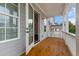 Enjoy the outdoors on this porch with wood flooring, white railings, and gray siding at 2140 Parkside Ln, Roswell, GA 30076