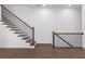 Staircase with dark wood steps, dark wood handrail, and black metal balusters at 2140 Parkside Ln, Roswell, GA 30076