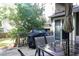 A back deck featuring an outdoor dining set with a table and four chairs with a grill covered in black at 3938 Landress Way, Lawrenceville, GA 30044