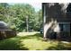 A home's grassy backyard featuring a partially visible neighboring house and a dark-colored pickup truck in the background at 3938 Landress Way, Lawrenceville, GA 30044
