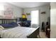 Bedroom with a full-sized bed, a desk with computer monitors, and a window with curtains at 3938 Landress Way, Lawrenceville, GA 30044