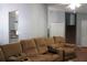 Comfortable living room featuring a large sofa and staircase at 3938 Landress Way, Lawrenceville, GA 30044