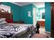 Main bedroom boasts an en-suite bathroom with a light wood vanity, with the bedroom featuring a large carved wooden bed at 3938 Landress Way, Lawrenceville, GA 30044