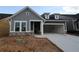 Charming new construction home with gray siding, stone accents, and attached two-car garage at 2040 Ripple Park Bnd, Canton, GA 30114