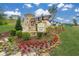 Great Sky Crescent Pointe community sign with beautiful landscaping, including colorful flowers and lush greenery at 2040 Ripple Park Bend, Canton, GA 30114