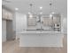 Stylish kitchen features stainless appliances, an island and pendant lights at 2040 Ripple Park Bnd, Canton, GA 30114