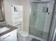 Bright bathroom featuring a white vanity with granite countertop and a glass-enclosed shower with white subway tile at 4678 Browns Mill Ferry Rd, Lithonia, GA 30038