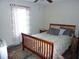 Cozy bedroom with a wooden bed frame, patterned curtains, and a colorful rug at 4678 Browns Mill Ferry Rd, Lithonia, GA 30038