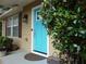 Inviting home with a vibrant blue front door, complemented by lush plants and charming details at 4678 Browns Mill Ferry Rd, Lithonia, GA 30038