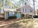 Charming two-story home featuring a well-maintained lawn, brick accents, and a vibrant blue front door at 4678 Browns Mill Ferry Rd, Lithonia, GA 30038