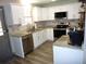 Bright kitchen features white cabinets, granite countertops, stainless steel appliances, and wood flooring at 4678 Browns Mill Ferry Rd, Lithonia, GA 30038