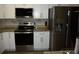 Modern kitchen with stainless steel appliances, white cabinets, and granite countertops at 4678 Browns Mill Ferry Rd, Lithonia, GA 30038