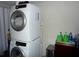 Modern laundry room with stacked washer and dryer at 4678 Browns Mill Ferry Rd, Lithonia, GA 30038