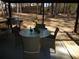 Back patio with dining set and wooded views at 4678 Browns Mill Ferry Rd, Lithonia, GA 30038
