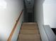 Carpeted stairway with wooden handrail leading to the upper level of the home at 4678 Browns Mill Ferry Rd, Lithonia, GA 30038