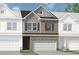 Charming brick and siding townhome with a two-car garage and well-manicured lawn at 208 Bastian Dr # 108, Villa Rica, GA 30180