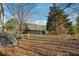Leaf-covered backyard with perimeter fence and an overgrown back perimeter at 2283 Noahs Ark Rd, Jonesboro, GA 30236