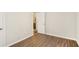 Empty bedroom with hardwood floors and a door leading to an adjacent bathroom at 2283 Noahs Ark Rd, Jonesboro, GA 30236