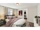 Comfortable staged bedroom with a cozy bed, decorative lamps, and a walk-in closet at 2283 Noahs Ark Rd, Jonesboro, GA 30236