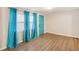 Bright living room showcasing luxury vinyl plank floors, a teal door, and abundant natural light at 2283 Noahs Ark Rd, Jonesboro, GA 30236