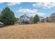 Expansive backyard featuring lush greenery, an adjacent home and an exterior deck at 4740 Arbor Meadows Dr, Cumming, GA 30040