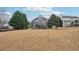 Large backyard with trees, adjacent homes and a wooden playset at 4740 Arbor Meadows Dr, Cumming, GA 30040