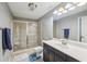 Well-lit bathroom featuring a glass shower, vanity with a sink, and modern fixtures at 4740 Arbor Meadows Dr, Cumming, GA 30040