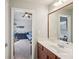 Bright bathroom features a vanity, large mirror, and view into a bedroom at 4740 Arbor Meadows Dr, Cumming, GA 30040