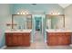 Dual sink bathroom with wood cabinets and large mirrors at 4740 Arbor Meadows Dr, Cumming, GA 30040