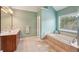 Bathroom with a soaking tub, vanity and tiled floors at 4740 Arbor Meadows Dr, Cumming, GA 30040