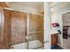 Bathroom featuring a glass-enclosed shower with brown tile and vanity at 4740 Arbor Meadows Dr, Cumming, GA 30040