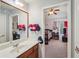 Well-lit bathroom featuring vanity and mirror with view into baseball themed bedroom at 4740 Arbor Meadows Dr, Cumming, GA 30040