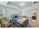 Comfortable bedroom with blue walls, a metal bed frame, and ensuite bathroom access at 4740 Arbor Meadows Dr, Cumming, GA 30040