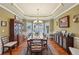 Elegant dining room with wainscoting, hardwood floors, and a beautiful bay window at 4740 Arbor Meadows Dr, Cumming, GA 30040