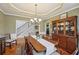Traditional dining room featuring hardwood floors, an elegant chandelier, and a beautiful china cabinet at 4740 Arbor Meadows Dr, Cumming, GA 30040