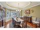 Charming dining room with a chandelier, hardwood floors, and large windows at 4740 Arbor Meadows Dr, Cumming, GA 30040