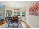 Bright dining room with chandelier, hardwood floors, and views of the outdoor deck at 4740 Arbor Meadows Dr, Cumming, GA 30040