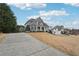 Beautiful home with a long driveway and well-maintained lawn, complemented by lush greenery and a detached garage at 4740 Arbor Meadows Dr, Cumming, GA 30040