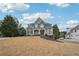 Charming two-story home featuring stone accents, a well-manicured lawn, and a welcoming front porch at 4740 Arbor Meadows Dr, Cumming, GA 30040