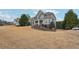 Attractive home with a stone facade, manicured lawn, and lovely landscaping, creating a welcoming curb appeal at 4740 Arbor Meadows Dr, Cumming, GA 30040