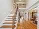 Inviting foyer featuring hardwood floors, a staircase, and an open view to the living spaces at 4740 Arbor Meadows Dr, Cumming, GA 30040