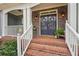 Welcoming front entrance with brick steps, a charming double door, and decorative plants, creating a warm ambiance at 4740 Arbor Meadows Dr, Cumming, GA 30040