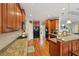Well-equipped kitchen features granite counters, wood cabinets, and stainless steel appliances at 4740 Arbor Meadows Dr, Cumming, GA 30040