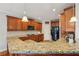 Spacious kitchen featuring granite countertops, wood cabinets, and modern appliances at 4740 Arbor Meadows Dr, Cumming, GA 30040