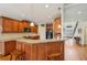 Well-equipped kitchen with granite countertops, a breakfast bar, and wood cabinetry at 4740 Arbor Meadows Dr, Cumming, GA 30040
