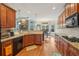 Open kitchen with granite countertops, modern appliances, breakfast bar, and views to living area at 4740 Arbor Meadows Dr, Cumming, GA 30040