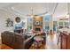 Cozy living room with a stone fireplace, hardwood floors, and natural light, creating a comfortable gathering space at 4740 Arbor Meadows Dr, Cumming, GA 30040