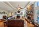 Inviting living room showcasing a stone fireplace, hardwood floors, and a cozy leather sofa at 4740 Arbor Meadows Dr, Cumming, GA 30040