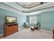 Spacious primary bedroom suite with a tray ceiling, ceiling fan, and generous natural light at 4740 Arbor Meadows Dr, Cumming, GA 30040
