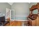 Comfortable music room features vintage organ, hardwood floors, and access to the stairway at 4740 Arbor Meadows Dr, Cumming, GA 30040